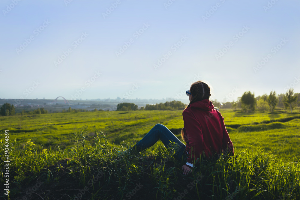 Girl posing, where a lot of grass in the field. Girl posing, where a lot of grass in the field.