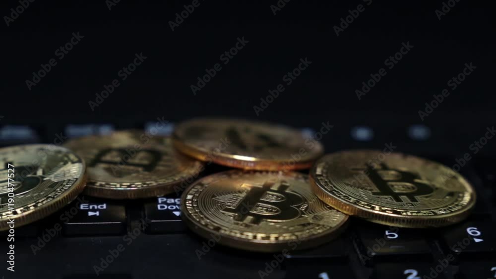 Gold coins bitcoins on the keyboard, close-up. Gold coins bitcoins on the keyboard, close-up.