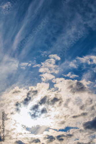 vertical background, rays of the sun make their way through dramatic clouds
