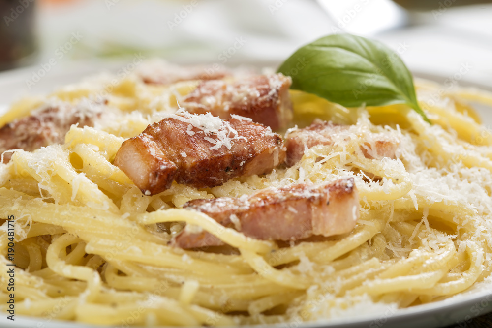 Plate with traditional Italian pasta Carbonara with grated parmesan Plate with traditional Italian pasta Carbonara with grated parmesan