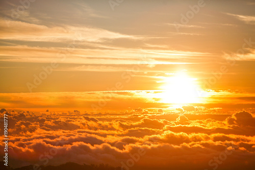 Fototapeta Naklejka Na Ścianę i Meble -  Beautiful aerial view above clouds with sunset. Airplane view