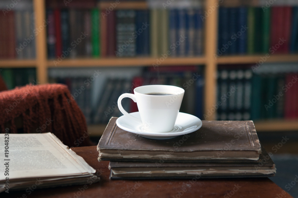 Sweet moments of relaxation with books and a cup of coffee. Vintage books, glasses, chair, library Sweet moments of relaxation with books and a cup of coffee. Vintage books, glasses, chair, library