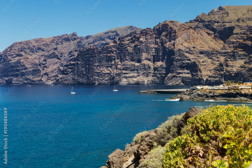 Giant rock formations known as Acantilados de Los Gigantes, located in Los Gigantes, a resort town in the Santiago del Teide municipality on the west coast of the Canary Island Tenerife, Spain