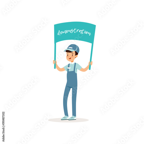 Young guy participates in peaceful demonstration. Volunteer holding banner in his hands. Smiling kid in blue working overall, t-shirt and cap. Flat vector design