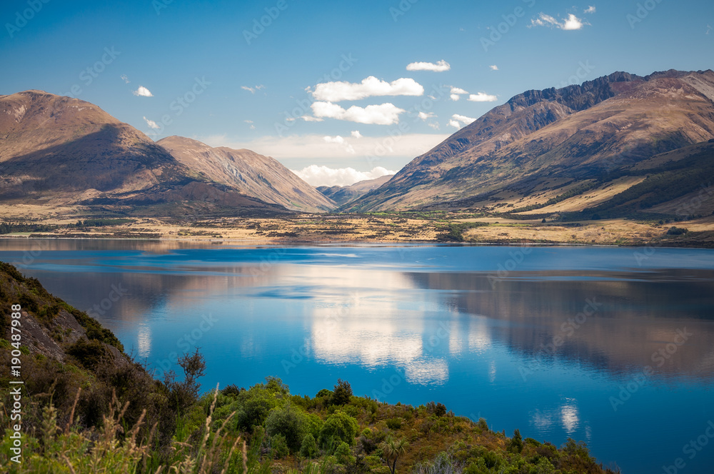 The calm waters of Lake Wakatipu in summer, New Zealand, South Island