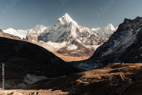 Ama Dablam mountain. Sun illuminates slopes. Himalayan mountains, Nepal.