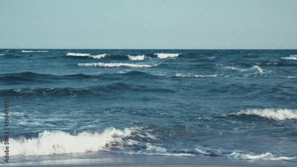 Sea coast. Large waves on the water surface. Clean sea horizon. Texture of water and sky Sea coast. Large waves on the water surface. Clean sea horizon. Texture of water and sky