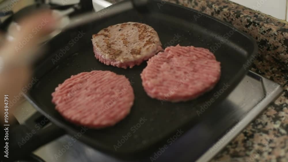 Cooking meat burgers in a saucepan. Cooking meat burgers in a saucepan.