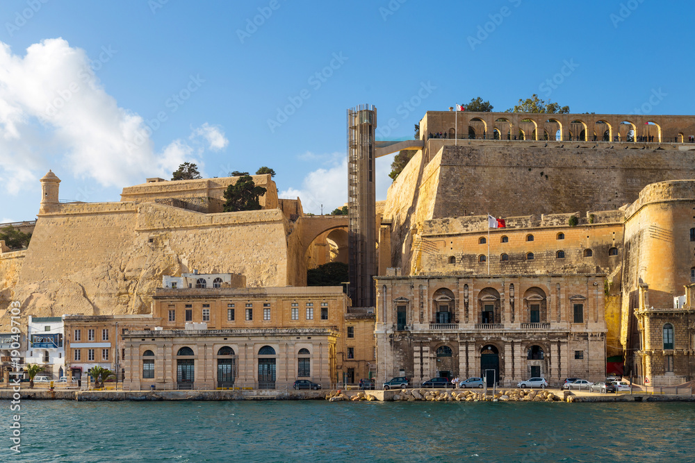 View on Valletta, capital city of Malta from the Grand Harbour with docks, The Saluting Battery and Barakka Lift.