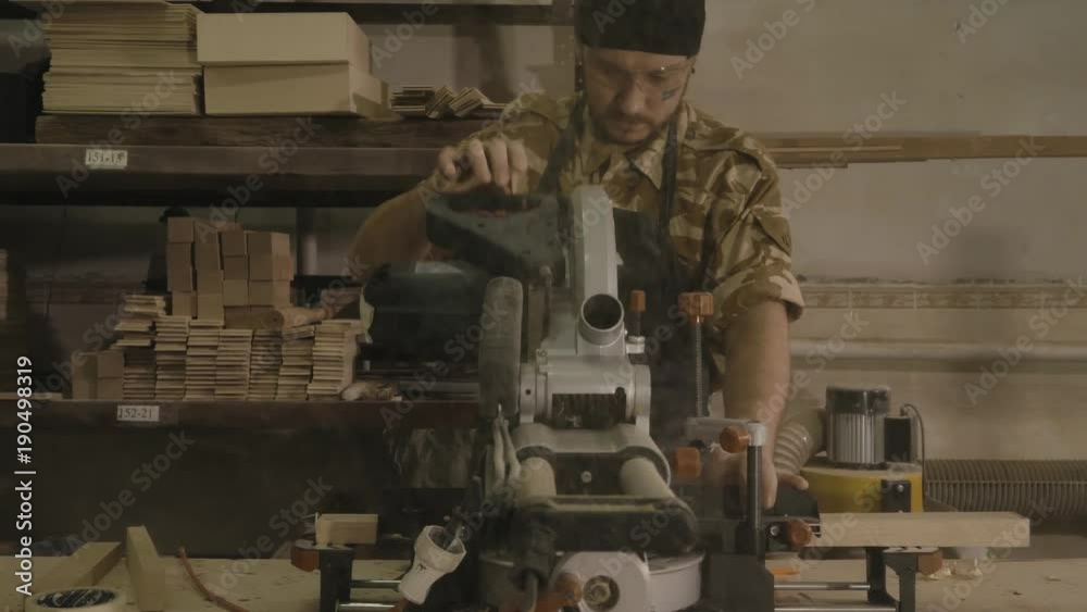 Using a chop saw to cut a piece of wood Stock Video Adobe Stock