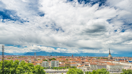 Turin Cityscape, Italy, Torino skyline, the Mole Antonelliana towering over the buildings. Wind storm clouds over the Alps in the background. © fabio lamanna