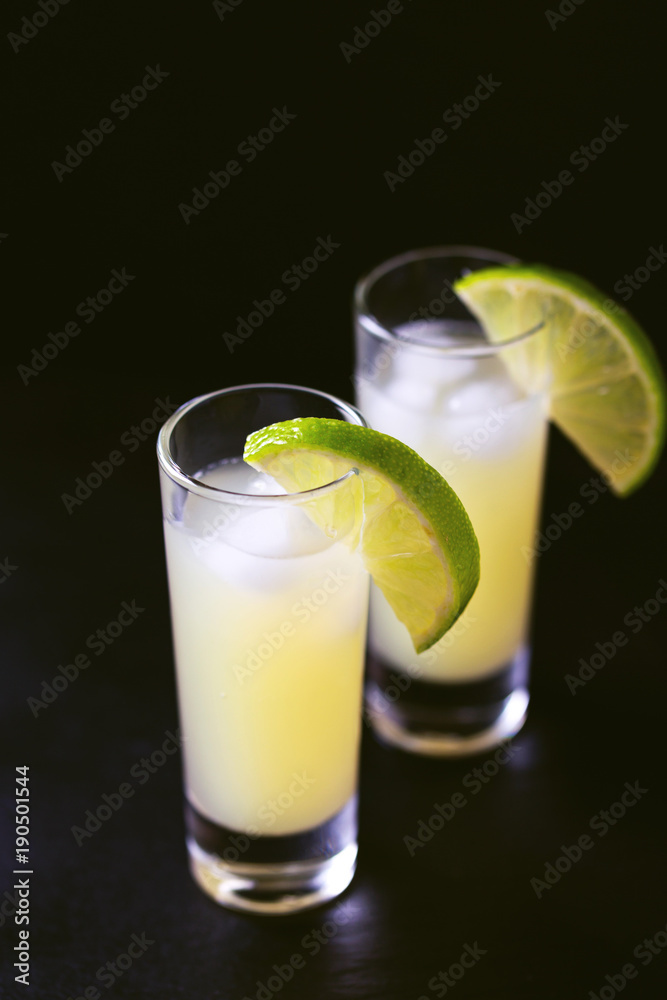 Italian lemon lime liqueur limoncello with ice and mint Italian lemon lime liqueur limoncello with ice and mint