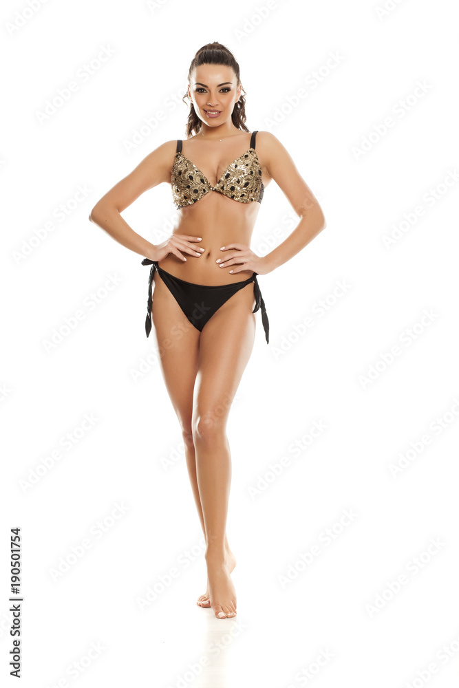 Beautiful fashion model in black bikini on white background Beautiful fashion model in black bikini on white background