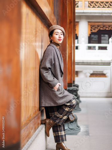Photography Beautiful young brunette woman with blur temple buildings background