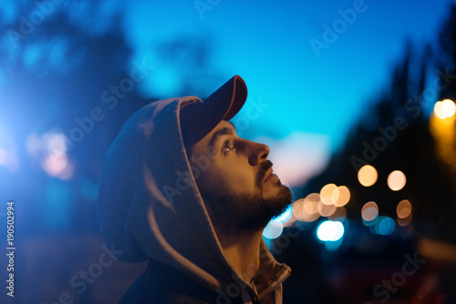The guy looks at the evening sky. Photos and low keys and with a soft focus. photo