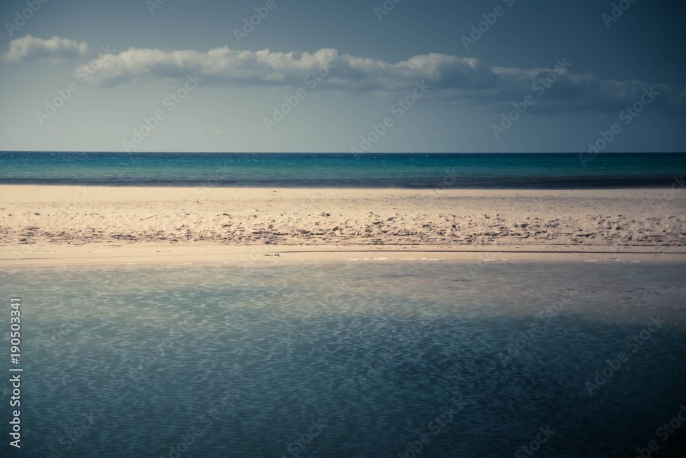Sotavento beach, Fuerteventura, Canary islands. Sea with sand strip creating multiple horizons. Good as sea wallpaper or background, pastel colors.
