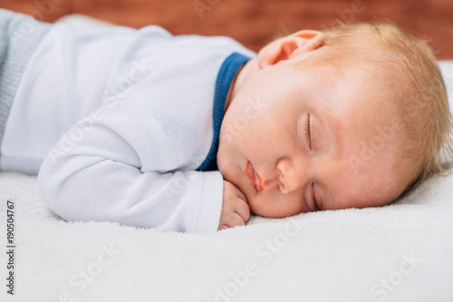 Sweet Little Newborn Baby Boy Sleeping On The Blanket