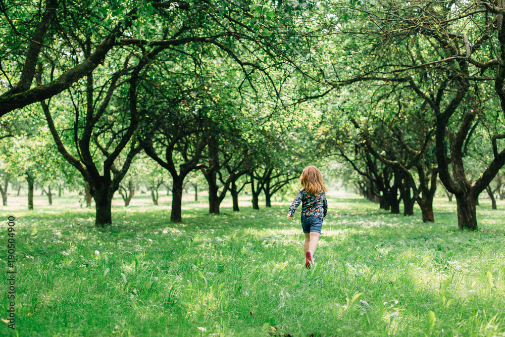 Cute little girl running in the park Cute little girl running in the park