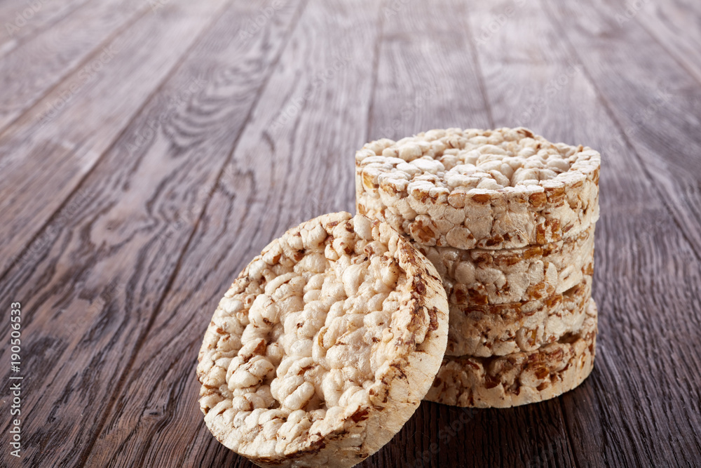 Stack of crispbreads on dark wooden table Stack of crispbreads on dark wooden table