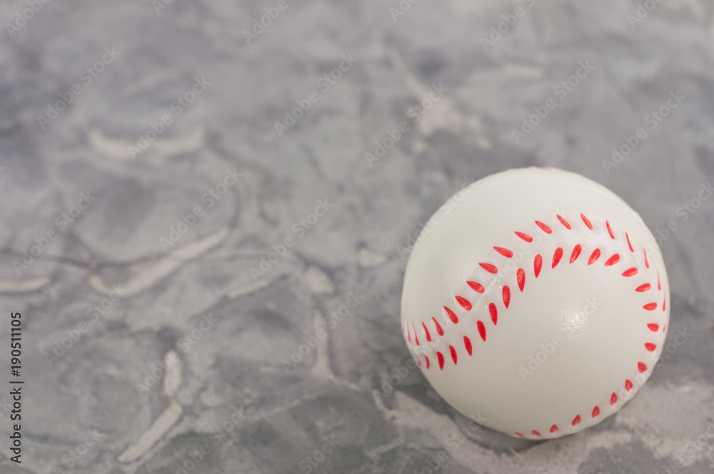 One new white and red soft rubber baseball ball on old worn cement One new white and red soft rubber baseball ball on old worn cement