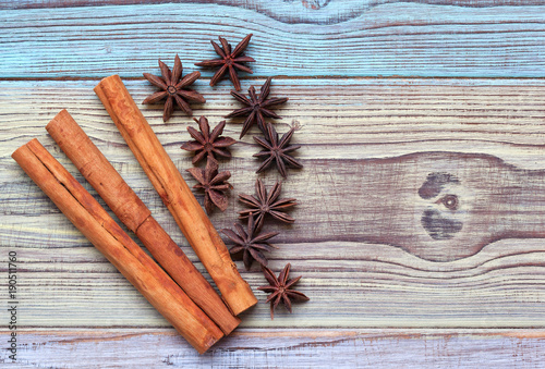 Cinnamon sticks and anise stars on a beautiful wooden background