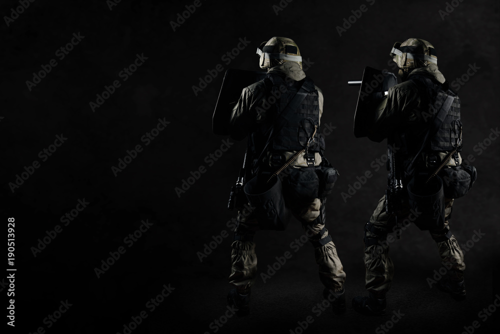 The man in the image of a member of the SWAT police with weapons The man in the image of a member of the SWAT police with weapons