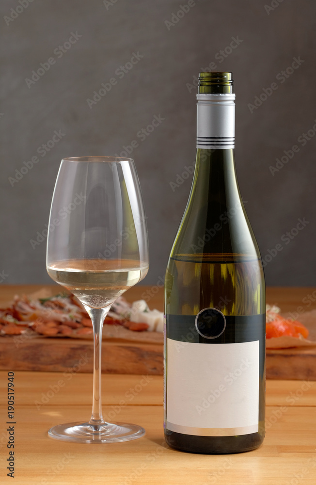 Mockup wine bottle with a glass of white wine 