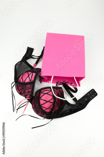 sexy pink lingerie bra with a present bag. Lingerie shopping for underwear - shopping concept