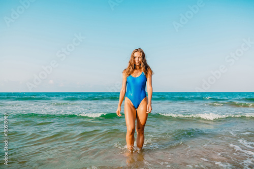 Attractive woman in bikini on sea. Tropical vacations