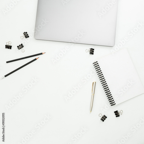 Modern office workspace with laptop, notebook and accessories on white background. Top view. Flat lay.