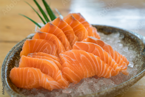 Raw salmon slice or salmon sashimi in Japanese style fresh serve on ice in bowl at Japanese restaurent.