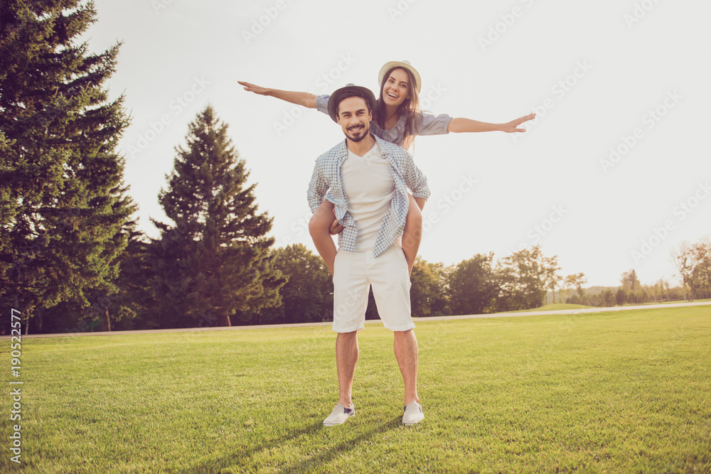 Cute sweet partner piggybacking his lady, she rides him. Date outside, well dressed, excited, lovely. Good day, happiness, friendship, stroll, holiday, fly, freedom concept Cute sweet partner piggybacking his lady, she rides him. Date outside, well dressed, excited, lovely. Good day, happiness, friendship, stroll, holiday, fly, freedom concept