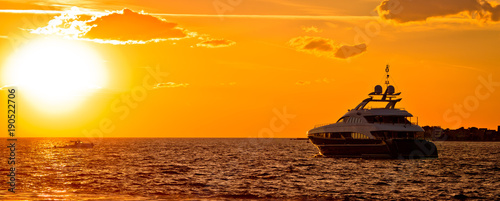 Yachtig on open sea at golden sunset panoramic view