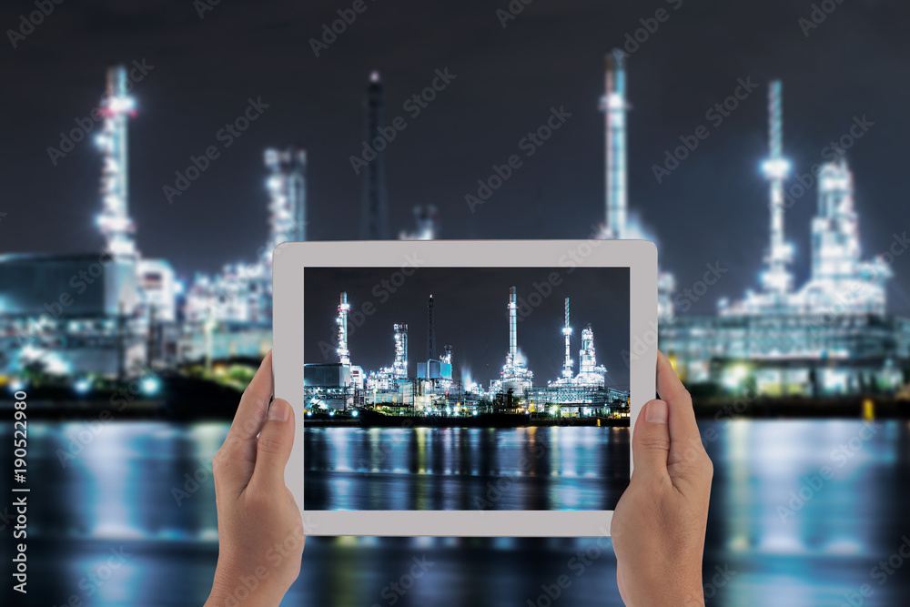 Double exposure with hand hilding taplet and factory industrial .Concept for industrial technology with background.