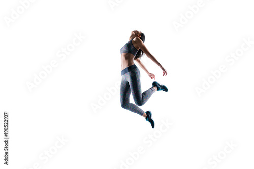 Deep breath after hard training! Concept of purity freedom. Side profile full-length portrait of fitness slender sporty woman is jumping up against white background, wearing sport outfit ans shoes © deagreez