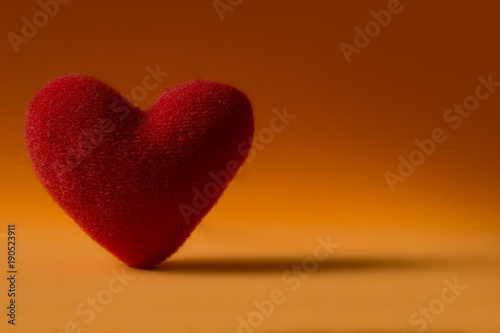 Red Heart stand alone on orange background. Valentine concept.