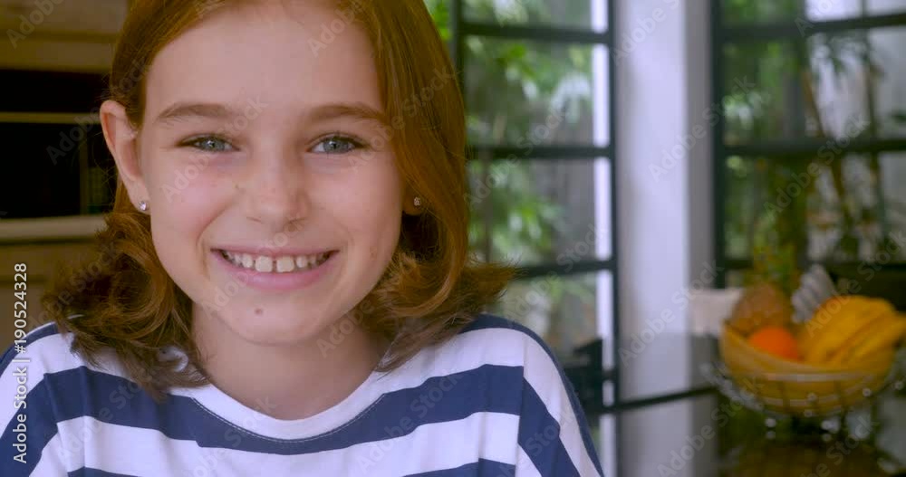 Adorable 10 year old girl smiling and looking at the camera