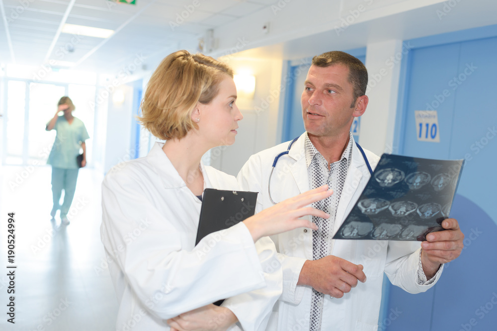 male and female doctor looking at patient xray male and female doctor looking at patient xray