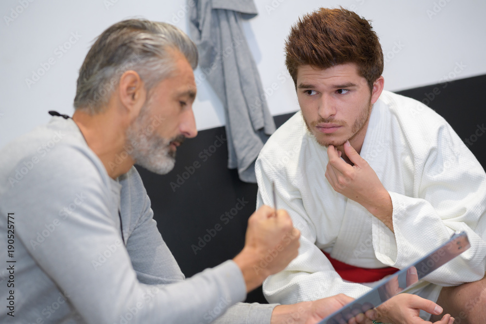 karate coach and student talking karate coach and student talking