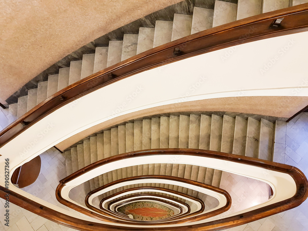 Obraz premium GENOA (GENOVA), ITALY, January 11, 2018 View to the beautiful spiral staircase in building , Spiral circle staircase decoration interior background.