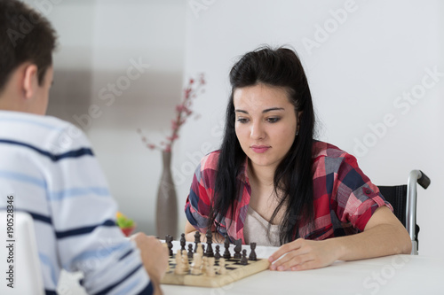 young couple playing chess indoo