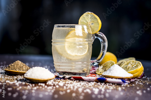 Close up of Indian most popular summer drink Nimbu pani or Nimbo sarbat,Lemonade in a transparent glass with salt and black pepper. photo