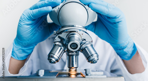 Close-up shot of microscope with metal lens at laboratory.