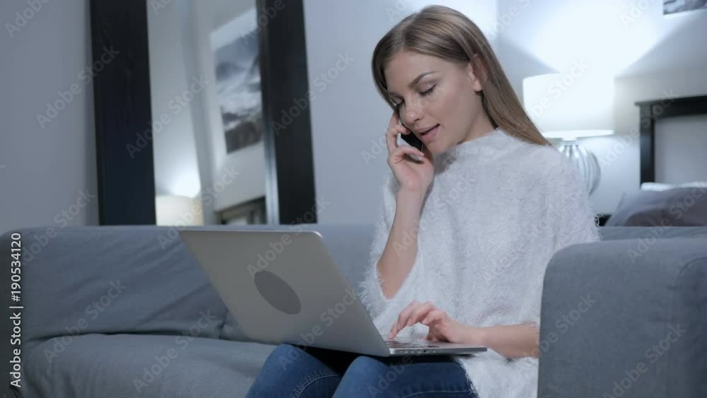 Woman Talking on Phone while Working on Laptop Woman Talking on Phone while Working on Laptop