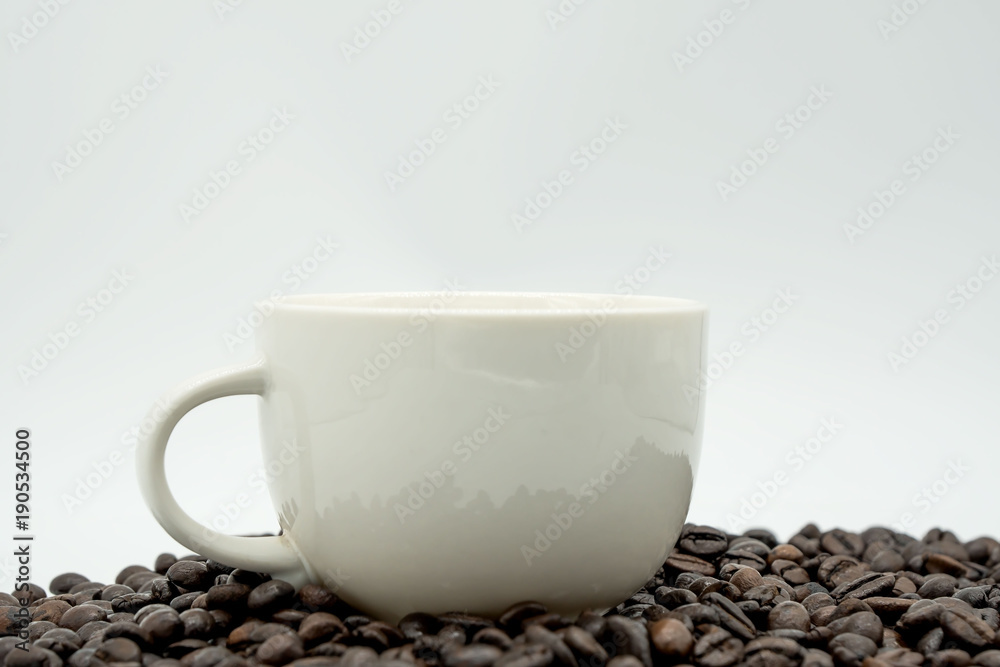 white coffee cup and coffee beans isolated on white background . white coffee cup and coffee beans isolated on white background .
