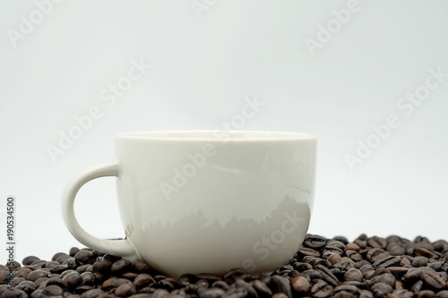 white coffee cup and coffee beans  isolated on white background .