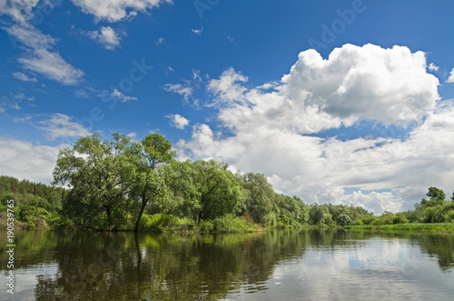 The lake is surrounded by trees along the banks