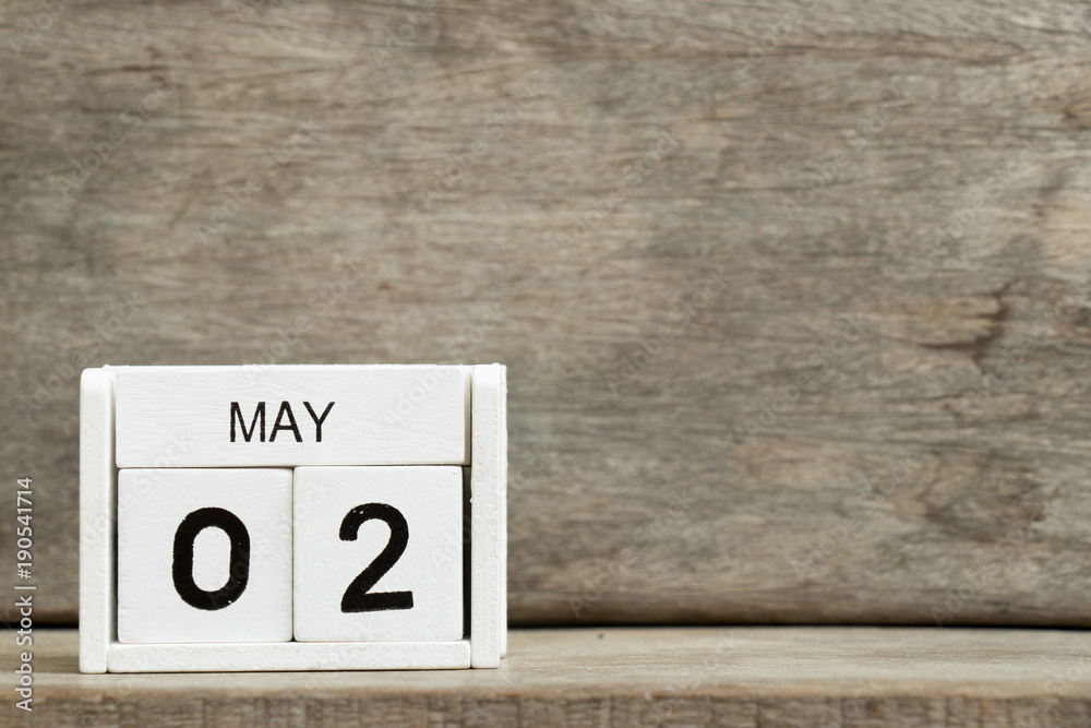 White block calendar present date 2 and month May on wood background White block calendar present date 2 and month May on wood background
