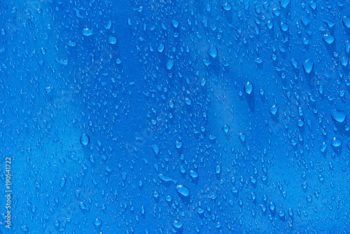 Rain drops on blue metal background