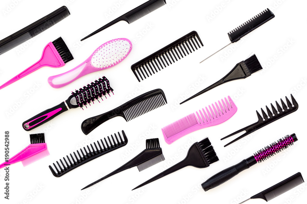 Hairdressing tools. Pattern with various combs and brushes on white background top view Hairdressing tools. Pattern with various combs and brushes on white background top view
